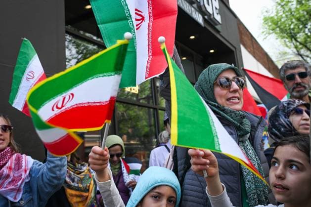 Woman With Israeli Flag Attacked During Edmonton Pro-Palestine Protest EDMONTON, CANADA JUNE 22: Protester hold Iranian flags as members of the local Palestinian diaspora, joined by Iranian and other Middle Eastern Muslim protesters, along with local activists, gather on White Avenue in Edmonton for the Hands Off Palestine, Iran, Syria, Yemen, Lebanon protest on June 22, 2025, in Edmonton, Alberta, Canada. Edmonton Canada Copyright: xArturxWidakx originalFilename: widak-womanwit250622_npQvy.jpg