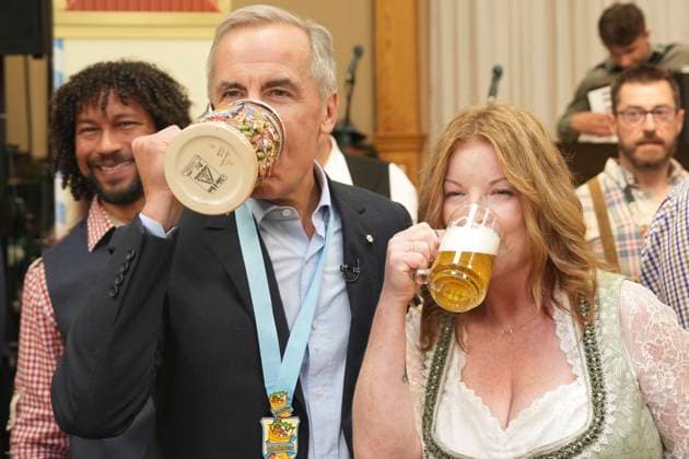 October 17, 2025, Breslau, On, Canada: Prime Minister Mark Carney, left, takes a sip of beer with Tracy Van Kalsbeek, Executive Director of the Board of Oktoberfest, after tapping a keg at an Oktoberfest event, at the Schwaben Club in Breslau, Ont., on Friday, Oct. 17, 2025. Breslau Canada - ZUMAc35_ 20251017_zaf_c35_045 Copyright: xChrisxYoungx