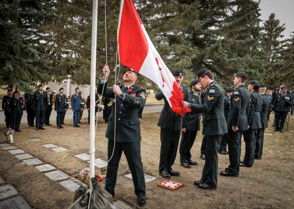 November 9, 2025, Calgary, Ab, CANADA: Members of the KingöÄÃ s Own Calgary Regiment lower a Canadian flag during a graveside ceremony honouring Cpl. Gawen Foster, who served with the 50th Canadian Infantry Battalion, Canadian Expeditionary Force, during the First World War, in Calgary, Sunday, Nov. 9, 2025. Calgary CANADA - ZUMAc35_ 20251109_zaf_c35_029 Copyright: xJeffxMcintoshx