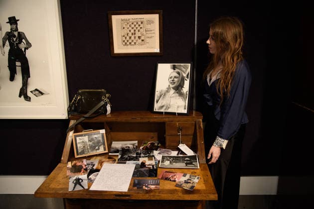Bonhams Sound & Cinema: With Property from The Marianne Faithfull Estate Sale - Bonhams, London, UK - 1 December 2025 A staff member views (bottom) - A Large Collection of Photographs, some professional and some personal owned by Marianne Faithfull (est. £600 - £800) and (top) - Work on paper, titled Babylon by Anita Pallenberg (est. £800 - £1k) which is on auction at Bonhams Sound & Cinema: With Property from The Marianne Faithfull Estate Sale ending from 3rd December 2025 at Bonhams in London, England, UK on Monday 1 December, 2025., Credit:Justin Ng Avalon UK, England, London, Bonhams Copyright: xJustinxNgx xAvalonx 1055809859
