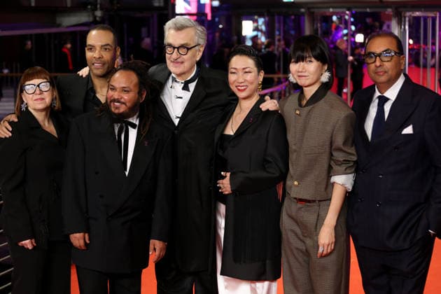 February 12, 2026, Berlin, Germany: International Jury members Shivendra Singh Dungarpur, Min Bahadur Bham, Jury President Wim Wenders, Bae Doona, Hikari, Ewa Puszczynska, and Reinaldo Marcus Green pose on the red carpet at the opening ceremony of the 76th Berlin International Film Festival (Berlinale), which is Europe s first major film festival of the year, in Berlin. The festival runs from February 12 to 22, 2026. Berlin Germany - ZUMAf146 20260212_zip_f146_088 Copyright: xRouzbehxFouladix
