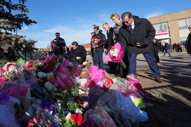 February 13, 2026, Tumbler Ridge, Bc, CANADA: Bloc Quebecois Leader Yves-Francois Blanchet, right, flanked by NDP interim Leader Don Davies, left to right, Conservative Leader Pierre Poilievre, MP Bob Zimmer, Prime Minister Mark Carney and his wife Diana Fox Carney, place flowers at a memorial for the victims of a mass shooting, in Tumbler Ridge, B.C., Friday, Feb. 13, 2026. Tumbler Ridge CANADA - ZUMAc35_ 20260213_zaf_c35_111 Copyright: xChristinnexMuschix