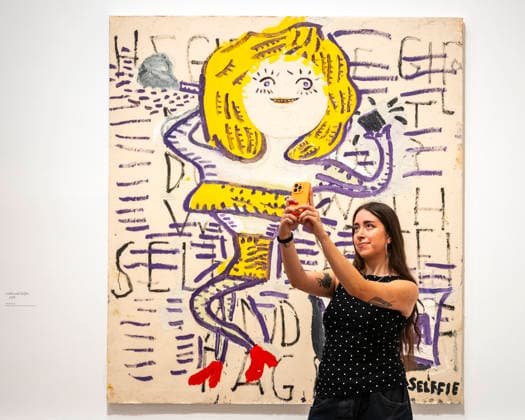 February 24, 2026, London, London, UK: LONDON, UK. A staff member with ‘Lolita and Selffieâ€⠢, 2018, at a preview of ‘Rose Wylie: The Picture Comes Firstâ€⠢, the largest survey of the work of Rose Wylie, RA, at the Royal Academy of Arts. The exhibition presents over 90 of her works from 28 February to 19 April 2026. London UK - ZUMAl94_ 20260224_zaf_l94_027 Copyright: xStephenxChungx