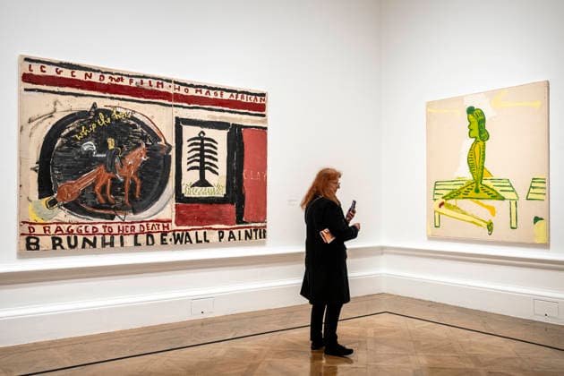 February 24, 2026, London, London, UK: LONDON, UK. A visitor with (L) ‘Brunhilde (Film Notes)â€⠢, 2024, and ‘Sitting on Bench, Red Shadowâ€⠢, 2007, at a preview of ‘Rose Wylie: The Picture Comes Firstâ€⠢, the largest survey of the work of Rose Wylie, RA, at the Royal Academy of Arts. The exhibition presents over 90 of her works from 28 February to 19 April 2026. London UK - ZUMAl94_ 20260224_zaf_l94_033 Copyright: xStephenxChungx