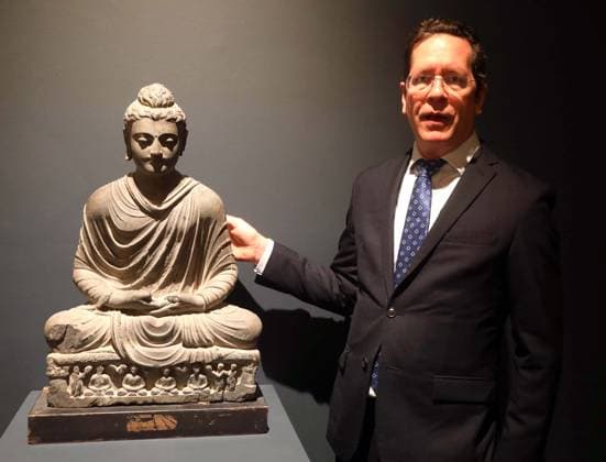 March 19, 2026, New York, New York, USA: Sothebyâ€⠢s Asian Art International Specialist JULIAN KING seen with a gray schist figure of Shakyamuni Buddha, Ancient region of Gandhara, 3rd - 4th century, estimate $40,000 - $70,000, seen on display during the press preview for Sotheby s New York Inaugural Asian Art Sales, the first ever held at the Breuer Building. New York USA - ZUMAk03_ 20260319_zaf_k03_011 Copyright: xNancyxKaszermanx