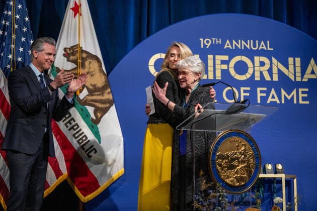 March 19, 2026, Sacramento, Ca, USA: First Partner Jennifer Siebel Newsom hugs Riane Eisler, groundbreaking systems scientist, cultural historian and futurist, alongside Gov. Gavin Newsom during the induction of the 19th class to the California Hall of Fame at the California Museum on Thursday, March 19, 2026, in Sacramento. Sacramento USA - ZUMAj89_ 20260319_zaf_j89_020 Copyright: xPaulxKitagakixJr.x