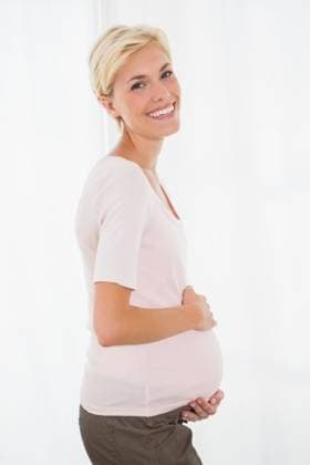 Portrait of smiling blonde pregnant Portrait of smiling blonde pregnant with white background, model released, Cape Town, South Africa, 03.02.2015, 533246.jpg, home, house, household, homey, apartment, domicile, abode, lifestyle, leisure, domestic life, casual clothing, pregnancy, expecting, pregnant, belly, maternity, holding, touching, anticipation, calm, peaceful, relaxing, content, happy, smiling, cheerful, fair hair, blonde, light hair, short hair 20s, Young Adult, Woman, Female, Caucasian, 20-24 Years, Young Women, Caucasian Ethnicity Indoors,Day
