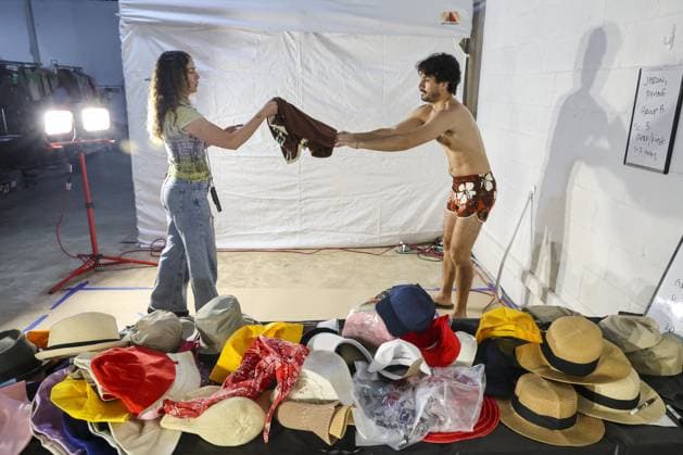 April 2, 2026, St. Pete Beach, Florida, USA: Key costumer Alcee Stoller, left, works with a swimsuit fitting with extra Jaron Payne, of St. Petersburg, during preparations for filming the movie â€oeThe Statement†on Thursday, April 2, 2026, in St. Pete Beach. The Oscar-winning director Tom McCarthy is leading production on the film, a dark comedy drama set in the 1980s, starring Paul Rudd, Evan Peters, Amy Ryan, Paul Giamatti, John Turturro, Tatiana Maslany and Jason Clarke. St. Pete Beach USA - ZUMAs70_ 20260402_zan_s70_009 Copyright: xDouglasxR.xCliffordx