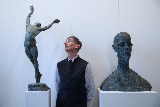 The Society of Portrait Sculptors: FACE 2026 Exhibition at Garrison Chapel, Chelsea Barracks, London, UK - Thursday 9 April 2026 A staff member views (L) - Transcendence by Andrian Melka and (R) - Don Quixote by Juraj Makarun at Garrison Chapel, Chelsea Barracks, London, England, UK on Thursday 9 April, 2026 as part of The Society of Portrait Sculptors: FACE 2026 Exhibition which runs from 13th - 26th April., Credit:Justin Ng Avalon UK, England, London, Garrison Chapel, Chelsea Barracks Copyright: xJustinxNgx xAvalonx 1089724262