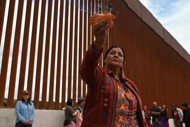 April 12, 2026, Tecate, Baja California, Mexico: Norma Alicia Mesa Calles, a member of native communities, mainly Kumeyaay native group, blessed people during a â€oeceremony†rally against the destruction of the Kuchamaa Mountain left by the construction of a new border wall at the US-Mexico Border in Tecate, Baja California, Mexico on Sunday, April 12, 2026. The Kuchamaa Mountain is considered a sacred site by native groups living in both sides of the border. Tecate Mexico - ZUMAm180 20260412_zip_m180_001 Copyright: xCarlosxA.xMorenox
