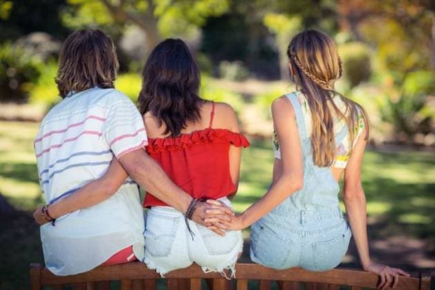 Man cheating on her woman in park Rear view of man cheating on her woman in park, model released, Cork, Ireland, 20.07.2016, 800627.jpg, couple, relationship, park, parkland, countryside, summer, sunny, casual clothing, sitting, bench, holding hands, infidelity, cheating, cheater, unfaithful, unaware, oblivious, vacation, holiday, recreation, weekend activities, travel, together, bonding, love, care, closeness