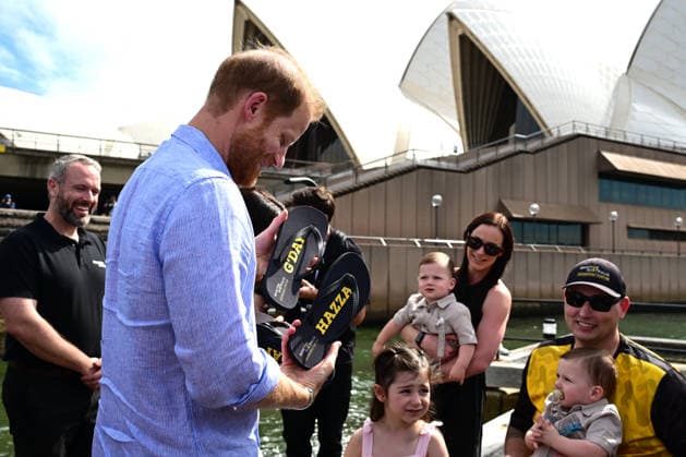 HARRY AND MEGHAN AUSTRALIA VISIT, Prince Harry and Meghan, the Duke and Duchess of Sussex are presented with a pair if thong™s by Invictus Australia veteran, Joel Vanderzwan accompanied by his wife, Alexandra, daughter Charlotte, and 9-month-old twin sons, Harrison and William Before boarding a boat for a tour of Sydney Harbour with Invictus Australia during a visit to Australia, Sydney, Friday, April 17, 2026. ( NO ARCHIVING SYDNEY NEW SOUTH WALES AUSTRALIA Copyright: xDEANxLEWINSx 20260417110930748479