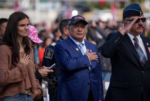 September 11, 2026, Surrey, Bc, CANADA: Retired New York fire department paramedic Roberto Abril, centre, stands during the singing of the U.S. national anthem during the Northwest 9 11 Memorial ceremony at the Peach Arch monument on the Canada-U.S. border between Surrey, B.C., and Blaine, Wash., in Surrey, B.C., on Friday, Sept. 11, 2026. Surrey CANADA - ZUMAc35_ 20260911_zaf_c35_144 Copyright: xDarrylxDyckx