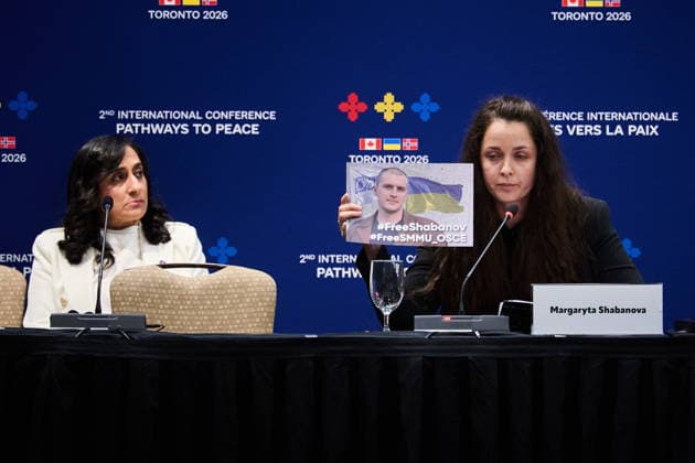 September 28, 2026, Toronto, On, Canada: Minister of Foreign Affairs Anita Anand, left, looks on as Margaryta Shabanova holds up a photo of her husband, a member of the Ukrainian forces who has been held in Russian captivity since 2021, as she speaks at the Pathways to Peace conference on the return of Ukrainian children held by Russian officials in Toronto, on Monday, Sept. 28, 2026. Toronto Canada - ZUMAc35_ 20260928_zaf_c35_145 Copyright: xSammyxKoganx