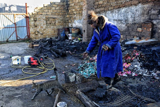 Olha Shylimina, head of the Loving Hearts animal shelter, calls a rescued cat against the backdrop of the scorched stone walls of the shelter’s destroyed main building in the Odesa region, Ukraine, September 29, 2026. During a nighttime Russian drone strike, the roof of the building - covering more than 400 square metres - was hit. The fire destroyed the premises along with stocks of grain, medicines, warm blankets, bowls, and other critical supplies. Thirteen animals - 10 cats and three dogs - died as a result of the strike and ensuing fire. (Photo by Nina Liashonok Ukrinform) Russia strikes animal shelter near Odesa Copyright: xNinaxLiashonokx