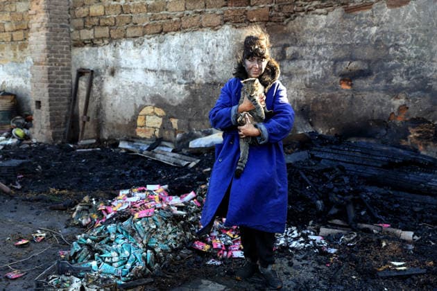 Olha Shylimina, head of the Loving Hearts animal shelter, holds a rescued cat against the backdrop of the scorched stone walls of the shelter’s destroyed main building in the Odesa region, Ukraine, September 29, 2026. During a nighttime Russian drone strike, the roof of the building - covering more than 400 square metres - was hit. The fire destroyed the premises along with stocks of grain, medicines, warm blankets, bowls, and other critical supplies. Thirteen animals - 10 cats and three dogs - died as a result of the strike and ensuing fire. (Photo by Nina Liashonok Ukrinform) Russia strikes animal shelter near Odesa Copyright: xNinaxLiashonokx