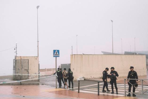 October 4, 2026, Ceuta, Ceuta, Spain: Police officers guard a cordoned-off street near El Trampolin beach in Ceuta during the eviction of the makeshift migrant camp. Spanish National Police began evicting the makeshift camp on El Trampolin beach in Ceuta on October 4, where more than 3,000 migrants, most of them young Moroccan men, were living. Dozens of police vans, armoured vehicles of the Police Intervention Units (UIP), drones and boats took part in the operation. People were taken by bus to the temporary centre at the Tarajal border to be identified, and the authorities plan to clear the beach in phases before October 15. The camp grew after a mass arrival at the end of July 2026 set off a migration and political crisis. Ceuta Spain - ZUMAs392 20261004_zip_s392_004 Copyright: xFabianxSuspensivox