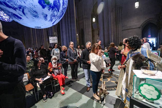 October 4, 2026, New York, New York, United States: The Very Reverend WINNIE VARGHESE, Dean of the Cathedral of St. John the Divine, gives a blessing to animals beneath Gaia, the seven-metre illuminated Earth installation by British artist LUKE JERRAM, in New York. The annual Blessing of the Animals, held in celebration of the Feast of St. Francis of Assisi, brings people and their beloved pets together at the Cathedral, honouring the relationship between people, animals and the natural world. New York United States - ZUMAo116 20261004_znp_o116_004 Copyright: xBiancaxOterox