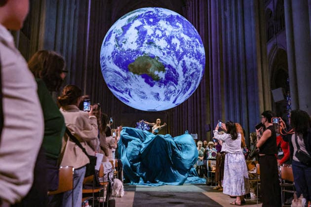 October 4, 2026, New York, New York, United States: Members of the Forces of Nature Dance Theatre Company perform beneath Gaia, the monumental illuminated Earth installation by British artist LUKE JERRAM, during the annual Blessing of the Animals at the Cathedral of St. John the Divine in New York. The celebration, held in honour of the Feast of St. Francis of Assisi, brings together dance, music, animals and their human companions in a celebration of the natural world. New York United States - ZUMAo116 20261004_znp_o116_009 Copyright: xBiancaxOterox