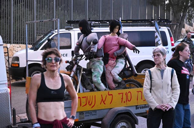 A truck pulls an effigy of Hamas terrorists kidnapping an Israeli woman at a protest of families and supporters of Israelis murdered by Hamas, on the third anniversary, of the deadliest day in Israel s history outside the Israeli Knesset, Parliament, in Jerusalem, on Wednesday, October 7, 2026. Demonstrators demand a state independent inquiry into the government s security failures, a request rejected by Israeli Prime Minister Benjamin Netanyahu. The banner reads The people shall remember their sons and daughters who were murdered a reference to the Yizkor prayer, with the date 27 10, the day of the upcoming general elections in Israel that are seen as a referendum on Netanyahu s power. JER2026100712 DEBBIExHILL
