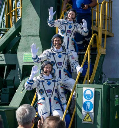 October 8, 2026, Baikonur, Kazakhstan: Baikonur, Kazakhstan. 14 July, 2026. Roscosmos cosmonaut Anna Kikina, top, NASA astronaut Anil Menon and Roscosmos cosmonaut Pyotr Dubrov wave farewell before boarding the Soyuz MS-29 spacecraft at the Baikonur Cosmodrome, July 14, 2026 in Baikonur, Kazakhstan. The trio launched to the International Space Station. Baikonur Kazakhstan - ZUMAp138 20261008_zaa_p138_013 Copyright: xBillxIngalls Nasax