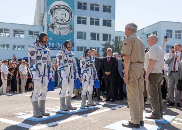 October 8, 2026, Baikonur, Kazakhstan: Baikonur, Kazakhstan. 14 July, 2026. NASA astronaut Anil Menon, left, and Roscosmos cosmonauts Pyotr Dubrov and Anna Kikina report to Roscosmos leadership as they depart Building 254 for their Soyuz launch at the Baikonur Cosmodrome, July 14, 2026 in Baikonur, Kazakhstan. Reporting to officials is a Russian launch day tradition. Baikonur Kazakhstan - ZUMAp138 20261008_zaa_p138_031 Copyright: xVictorxZelentsov Nasax