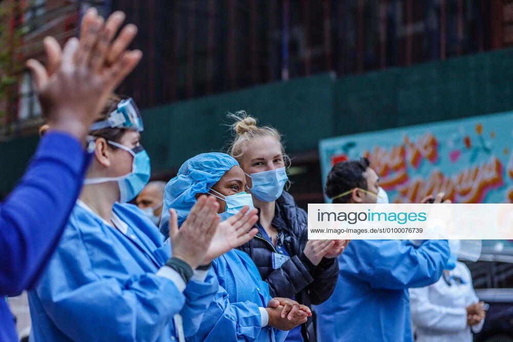 Health professionals are honored by residents and firefighters outside a Manhattan hospital in New York City on Monday during the Coronavirus COVID-19 pandemic in the United States. New York USA - ZUMAc233 20200427_zsp_c233_046