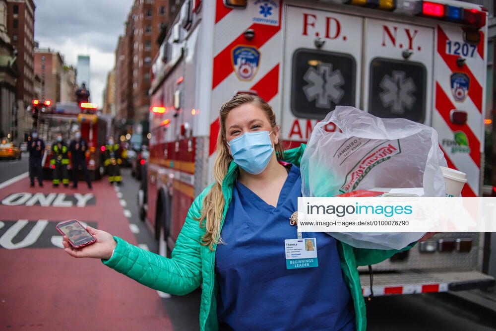 Health professionals are honored by residents and firefighters outside a Manhattan hospital in New York City on Monday during the Coronavirus COVID-19 pandemic in the United States. New York USA - ZUMAc233 20200427_zsp_c233_060