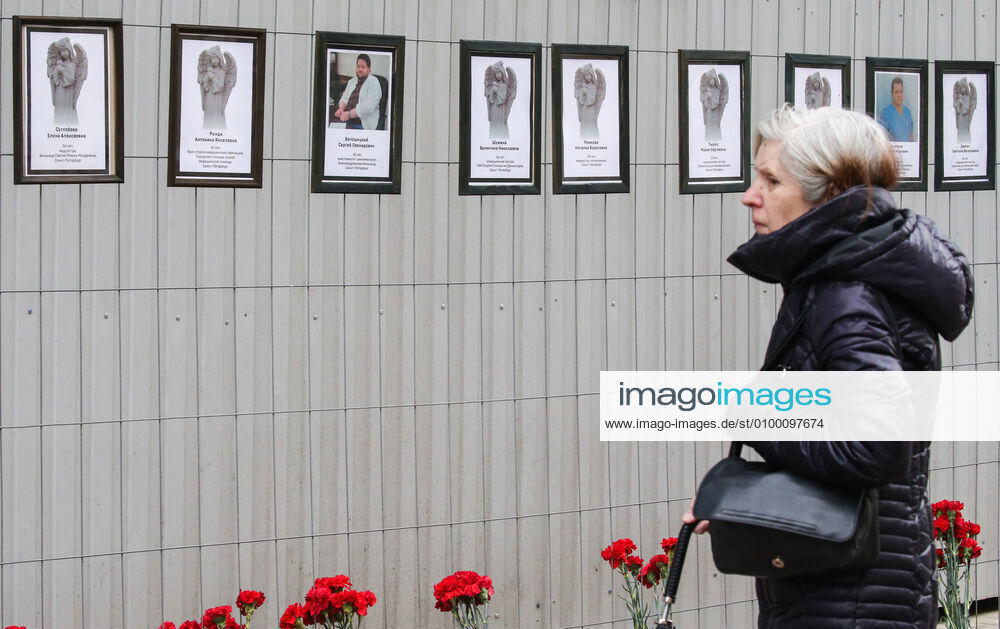 A woman by portraits of medical workers who died after contracting the novel coronavirus by the offices of St Petersburg s Healthcare Committee in Malaya Sadovaya Street. The wall of memory was created by St Petersburg resident Irina Maslova. Peter Kovalev TASS TS0D7523