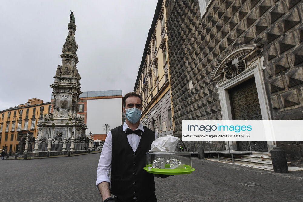Bartender is on his way to deliver coffee in Naples, after the lockdown due to Government Decree declaring all of Italy a protected area to combat Covid-19 - Coronavirus infection. A new Government Decree has established rules for gradually reopening economic and social activities from today.