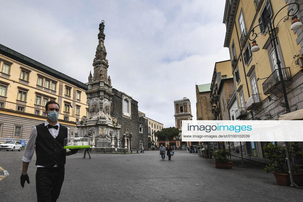 Bartender is on his way to deliver coffee in Naples, after the lockdown due to Government Decree declaring all of Italy a protected area to combat Covid-19 - Coronavirus infection. A new Government Decree has established rules for gradually reopening economic and social activities from today.