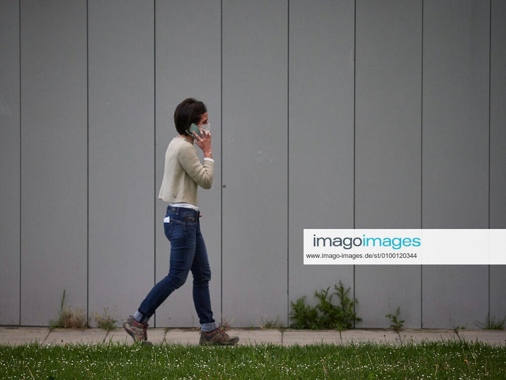 A woman walks talking on the mobile phone in the Navarra Hospital Complex during a Covid-19 Pandemic on April 28, 2020 in Pamplona, Navarra, Spain Pamplona SPAIN - ZUMAa181 20200428_zaa_a181_047