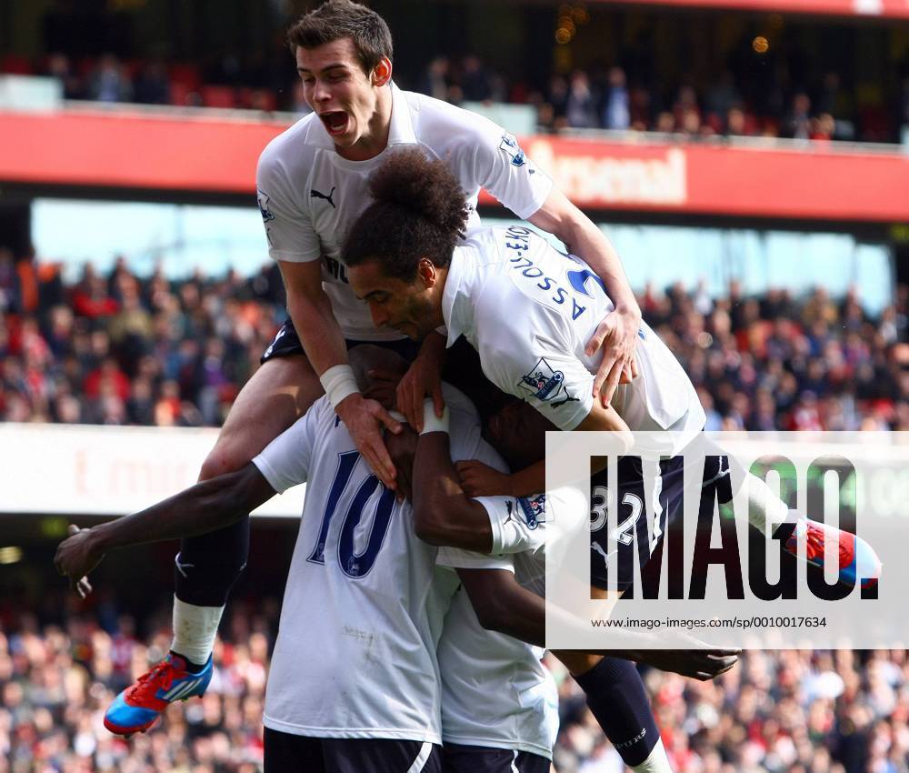Football - Premier League - Arsenal FC London vs. Tottenham Hotspur - Tottenham s Gareth Bale and Benoit Assou-Ekotto mob Emmanuel Adebayor following his goal from the penalty spot at the Emirates Stadium