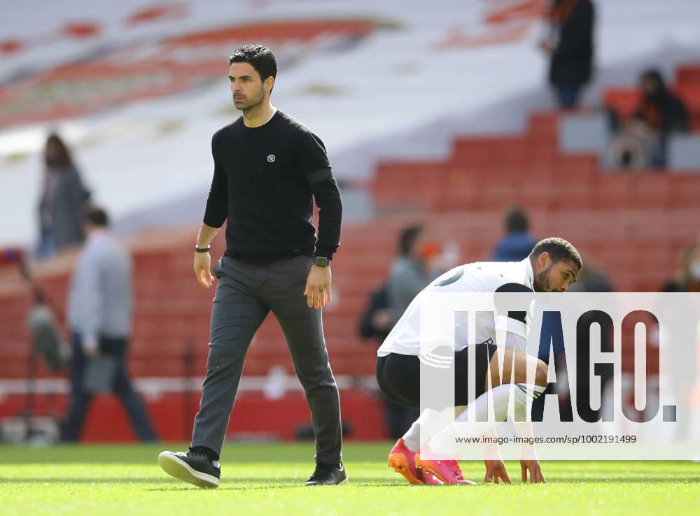 London, England, 18th April 2021. Mikel Arteta manager of Arsenal walks past a dejected Ivan Cavaleiro of Fulham during the Premier League match at the Emirates Stadium, London. Picture credit should read: David Klein Sportimage . SPI-1007-0060