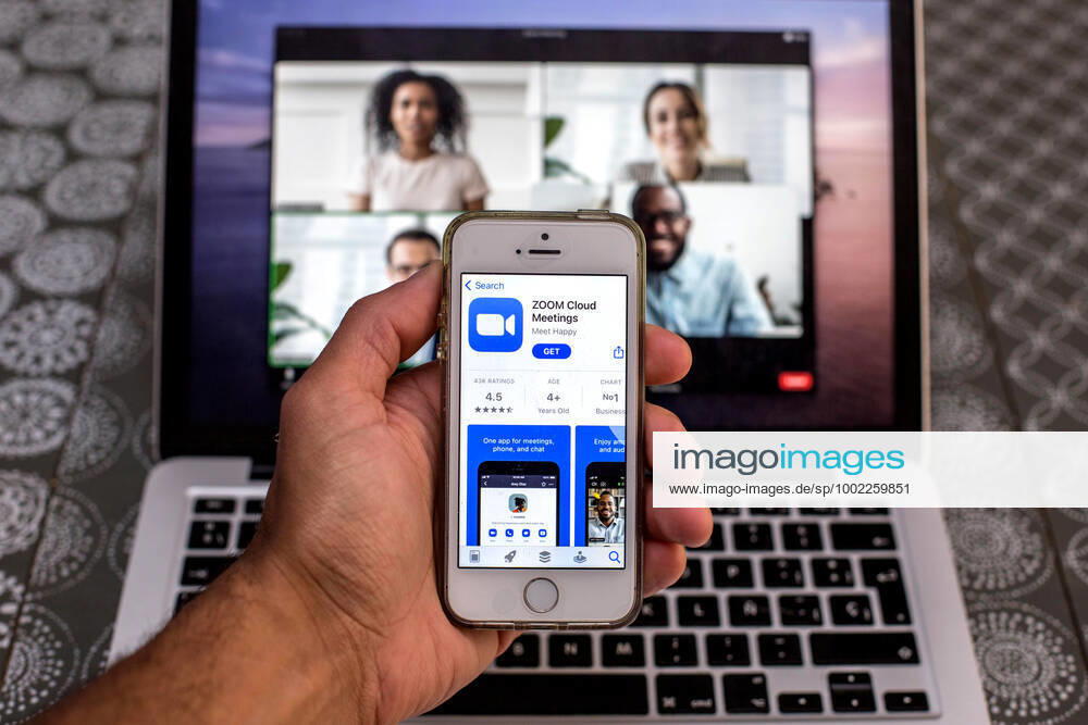 In this photo illustration, the Zoom app in App Store seen displayed on a smartphone screen and a Zoom Desktop on a laptop in the background. Barcelona Spain - ZUMAd159 20210420_zia_d159_091