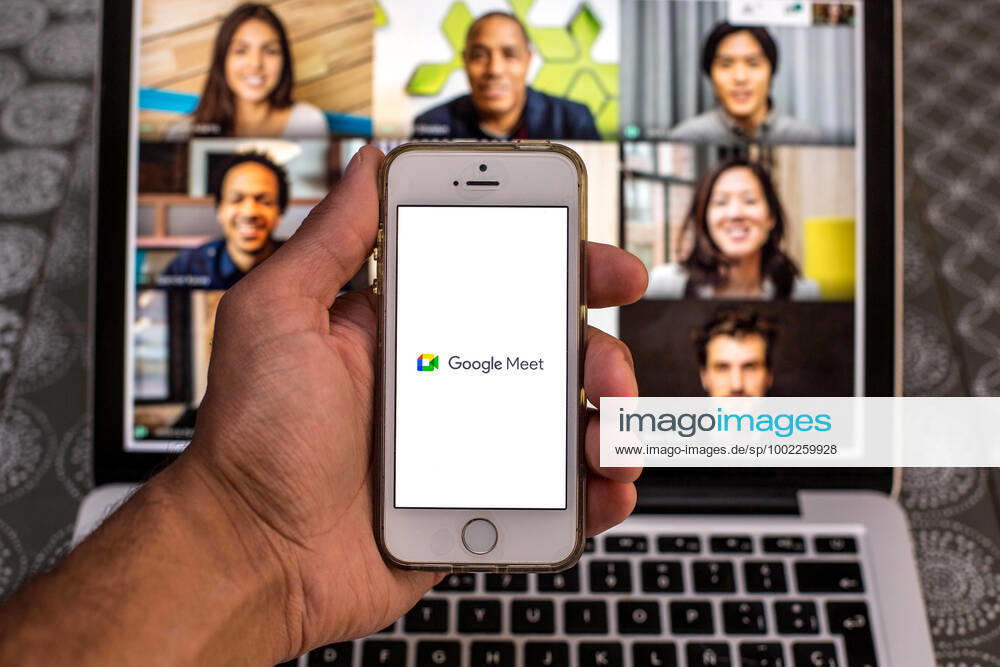 In this photo illustration, the Google Meet app seen displayed on a smartphone screen and a Google Meet Desktop on a laptop in the background. Barcelona Spain - ZUMAd159 20210420_zia_d159_095