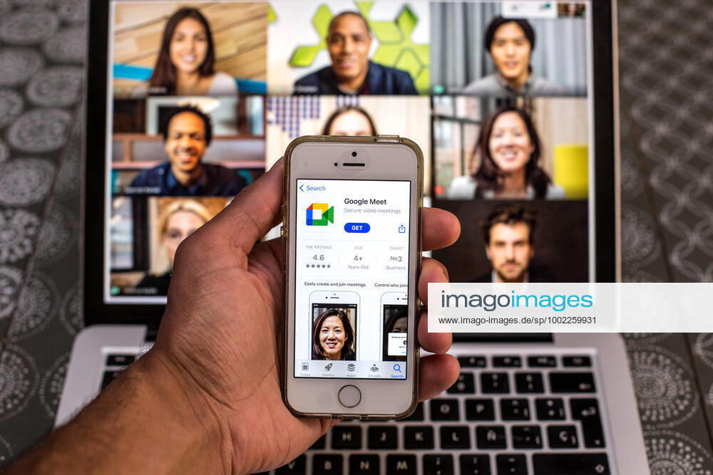 In this photo illustration, the Google Meet app in App Store seen displayed on a smartphone screen and a Google Meet Desktop on a laptop in the background. Barcelona Spain - ZUMAd159 20210420_zia_d159_096