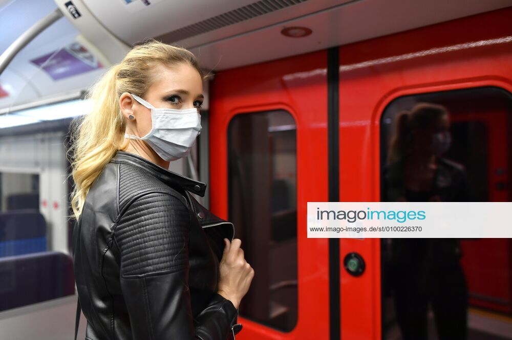 Frau mit Mundschutzmaske, steht in S-Bahn, Corona-Krise, Stuttgart, Baden-Württemberg, Deutschland, Europa