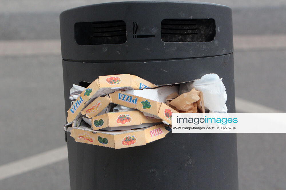 Pizza Schachteln stapeln sich nach einem Außer Haus Verzehr in einem überfüllten Mülleimer in der Innenstadt von Mannheim, Baden Württemberg, Deutschland