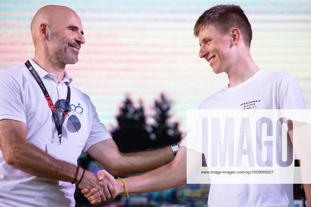Two-time Tour de France winner Tadej Pogacar shakes hands with Pavel Mardonovic, head of the Slovenian Cycling Federation, on stage at a reception in his honour in Komenda, his hometown. .Pogacar won the Tour de France for the second time in a row and bronze medal at the Tokyo Olympic Games, Olympische Spiele, Olympia, OS Komenda Slovenia - ZUMAs197 20210813_zaa_s197_173