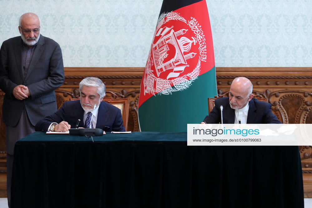 (200518) -- KABUL, May 18, 2020 -- Afghan President Mohammad Ashraf Ghani (R) and his political rival Abdullah Abdullah sign an agreement at Afghan Presidential Palace in Kabul, Afghanistan, May 17, 2020. Afghanistan s President Mohammad Ashraf Ghani and his rival Abdullah Abdullah, who also claimed victory in the presidential election, inked an agreement on Sunday to end the political deadlock following last year s presidential election, presidential spokesman Sediq Sediqqi said on Twitter. (Afghan President Palace Handout via Xinhua) AFGHANISTAN-KABUL-POLITICAL DEADLOCL- AGREEMENT ChenxXin