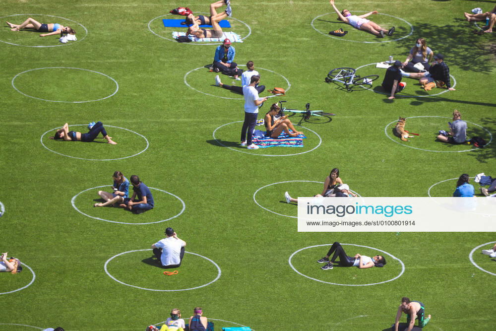 People are seen practising social distancing in white circles in Domino Park, during the Covid-19 pandemic on May 17, 2020 the in Brooklyn borough of New York City. New York USA - ZUMAc233 20200517_zsp_c233_032