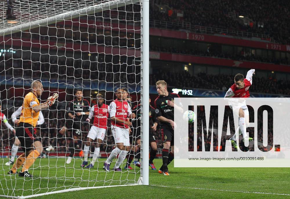 Arsenals Laurent Koscielny scoring his sides opening goal Arsenal v AC Milan, UEFA Champions League, Knockout round, Second Leg at the Emirates, London. 6th March 2012 .