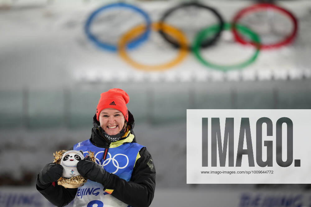 KW06 China Olympics 2022 Biathlon Women 8106970 07.02.2022 Gold medalist Germany s Denise Herrmann celebrates on the podium during the flower ceremony for the biathlon women s 15 km individual competition during the Beijing 2022 Winter Olympic Games, Olympische Spiele, Olympia, OS at National Biathlon Centre in Zhangjiakou, China. Ramil Sitdikov Sputnik Zhangjiakou China