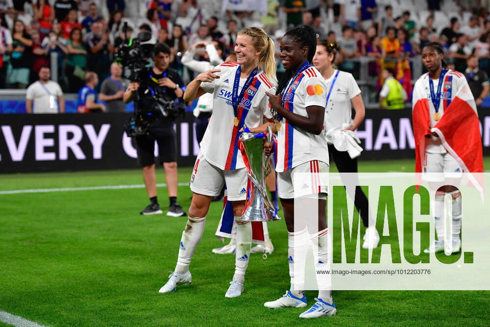 FC Barcelona, Barca v Olympique Lyon, UEFA Women?s Champions League final, football, Turin, Italy Turin, Italy. 21st, May 2022. Ada Hegerberg (14) and Mbock Bathy (29) of Olympique Lyon is celebrating and seen with the Champions League trophy after the UEFA Women?s Champions League final between Barcelona and Olympique Lyon at Juventus Stadium in Turin. Turin Italy