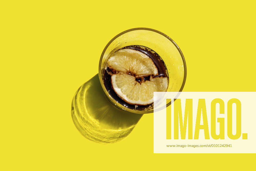 Studio shot of glass of cola with lemon slices GEMF03609