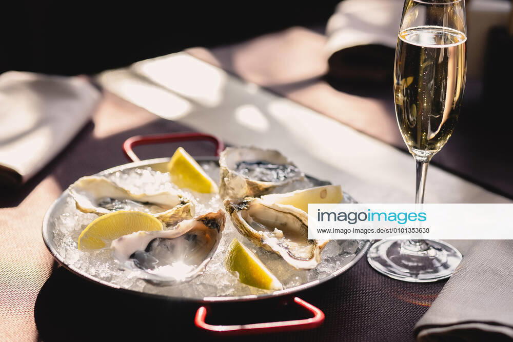 Plate with oysters, lemon and ice and a glass of champagne Rivne, Rivne Oblast, Ukraine CR_VIYA200415-349771-01