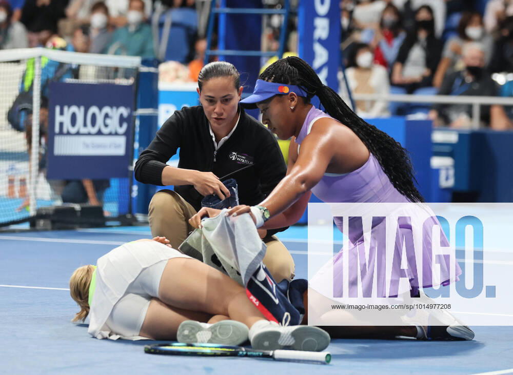 Tokyo, Japan - Daria Saville of Australia lays on the court as she collapsed while Japan s Naomi Osaka (R) brings a towel for her at the singles first round match at the Toray Pan Pacific Open tennis tournament at the Ariake Coliseum in Tokyo on Tuesday, September 20, 2022. Saville retired the game as her left knee injury and Osaka advanced to the second round. Noxthirdxpartyxsales (199076134)