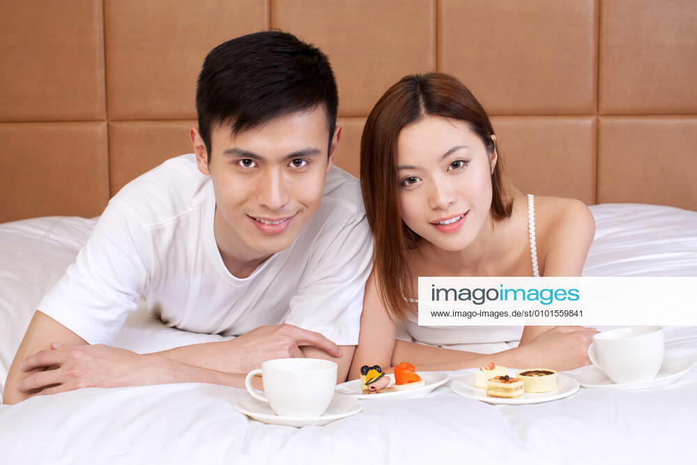 A couple enjoying life in a hotel room 55295075424535909
