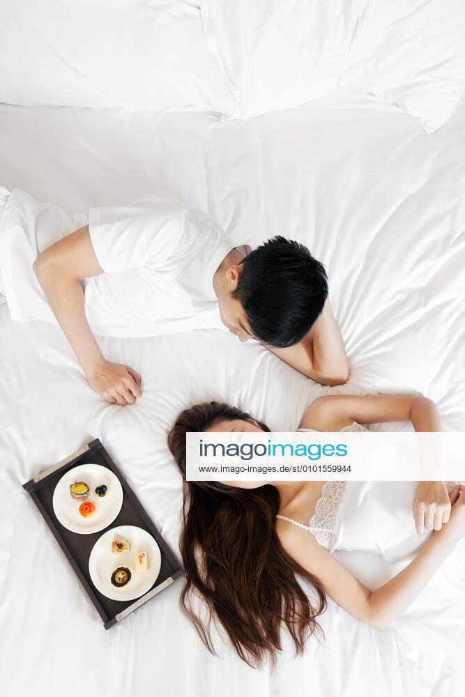A couple enjoying life in a hotel room 55295075424537273